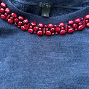 J. Crew women's size M crewneck sweatshirt, navy with red beadwork around neck.